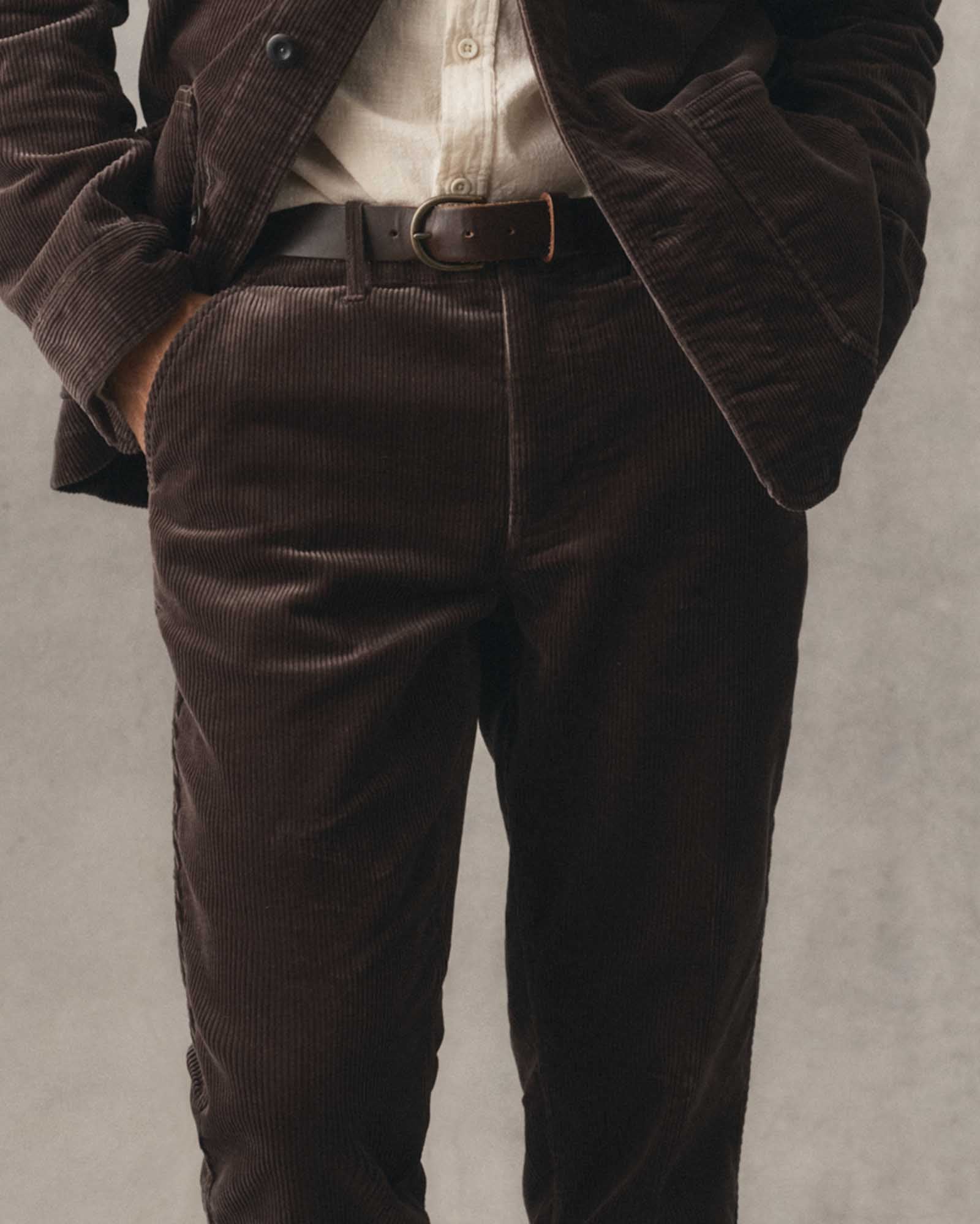 fit model posing in The Carnegie Pant in Soil Corduroy, Bottoms by Taylor Stitch