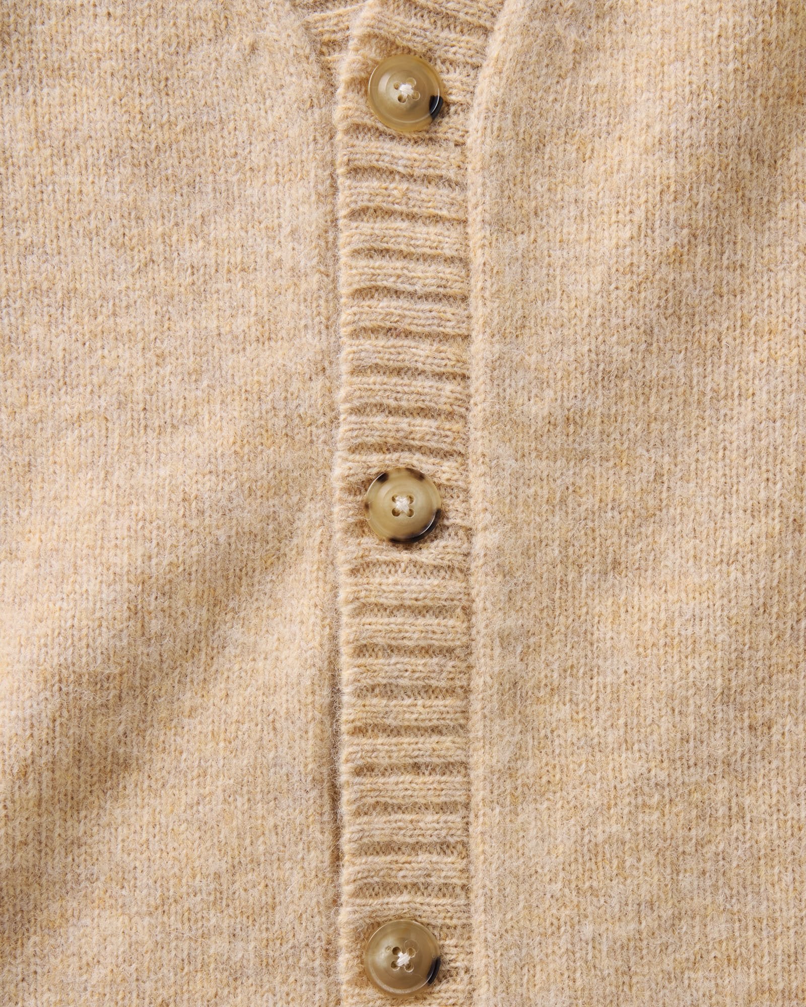 material shot of the button on The Eastmoor Cardigan in Oatmeal Wool, Knits by Taylor Stitch
