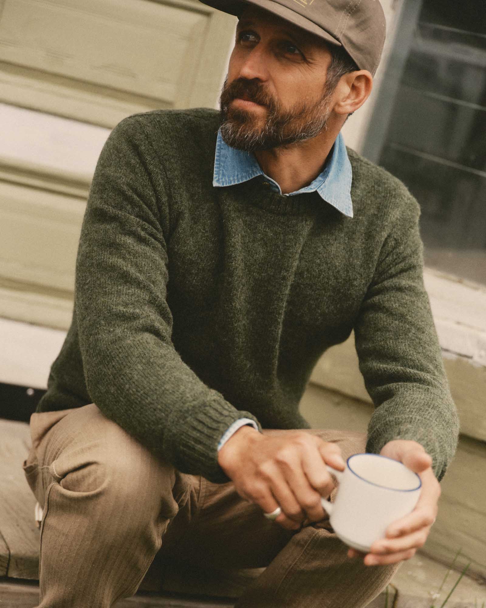 fit model sitting wearing The Eastmoor Sweater in Spruce Wool, Knits by Taylor Stitch