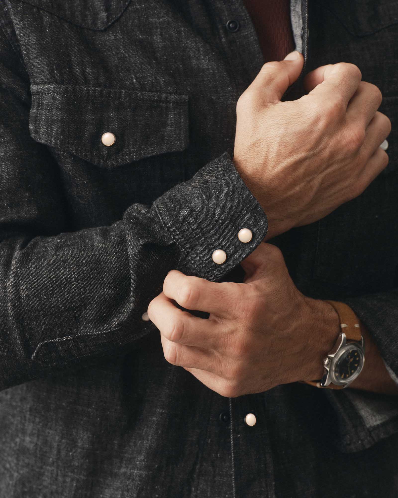 fit model adjusting the cuff on The Glacier Shirt in Black Indigo Hemp Denim, Wovens by Taylor Stitch