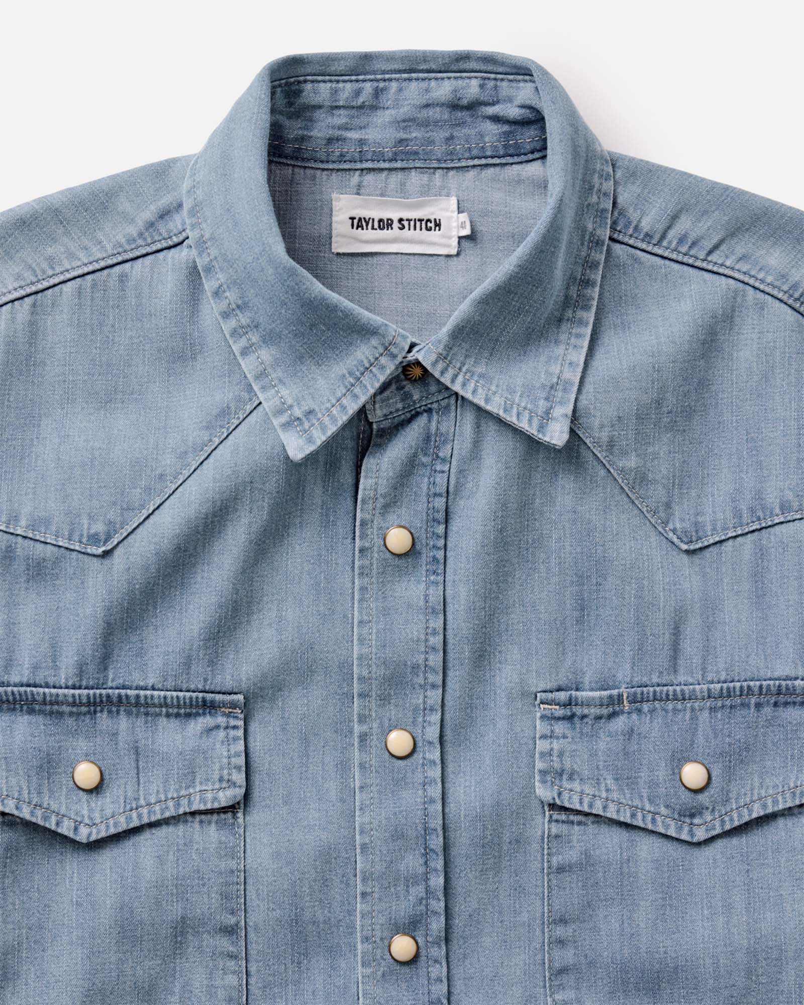 flatlay of the collar on The Glacier Shirt in Washed Indigo Selvedge Denim, Wovens by Taylor Stitch