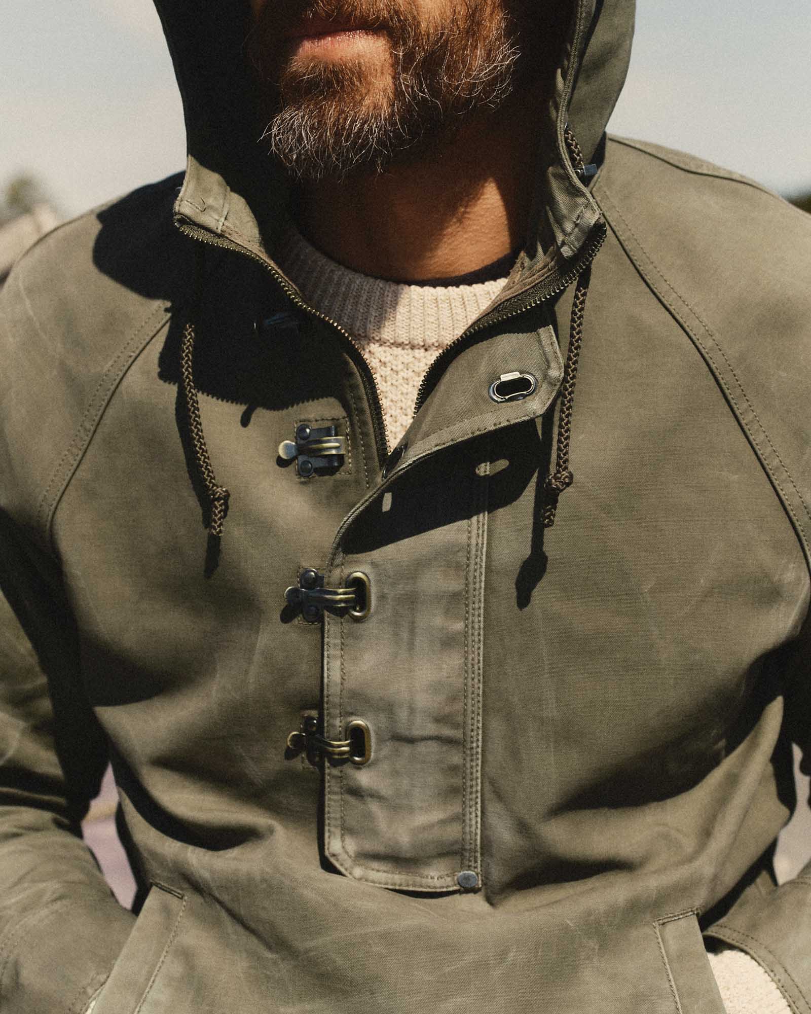 fit model showing off the clasps on The Hatteras Anorak in Fatigue Olive Dry Wax Canvas, Outerwear by Taylor Stitch