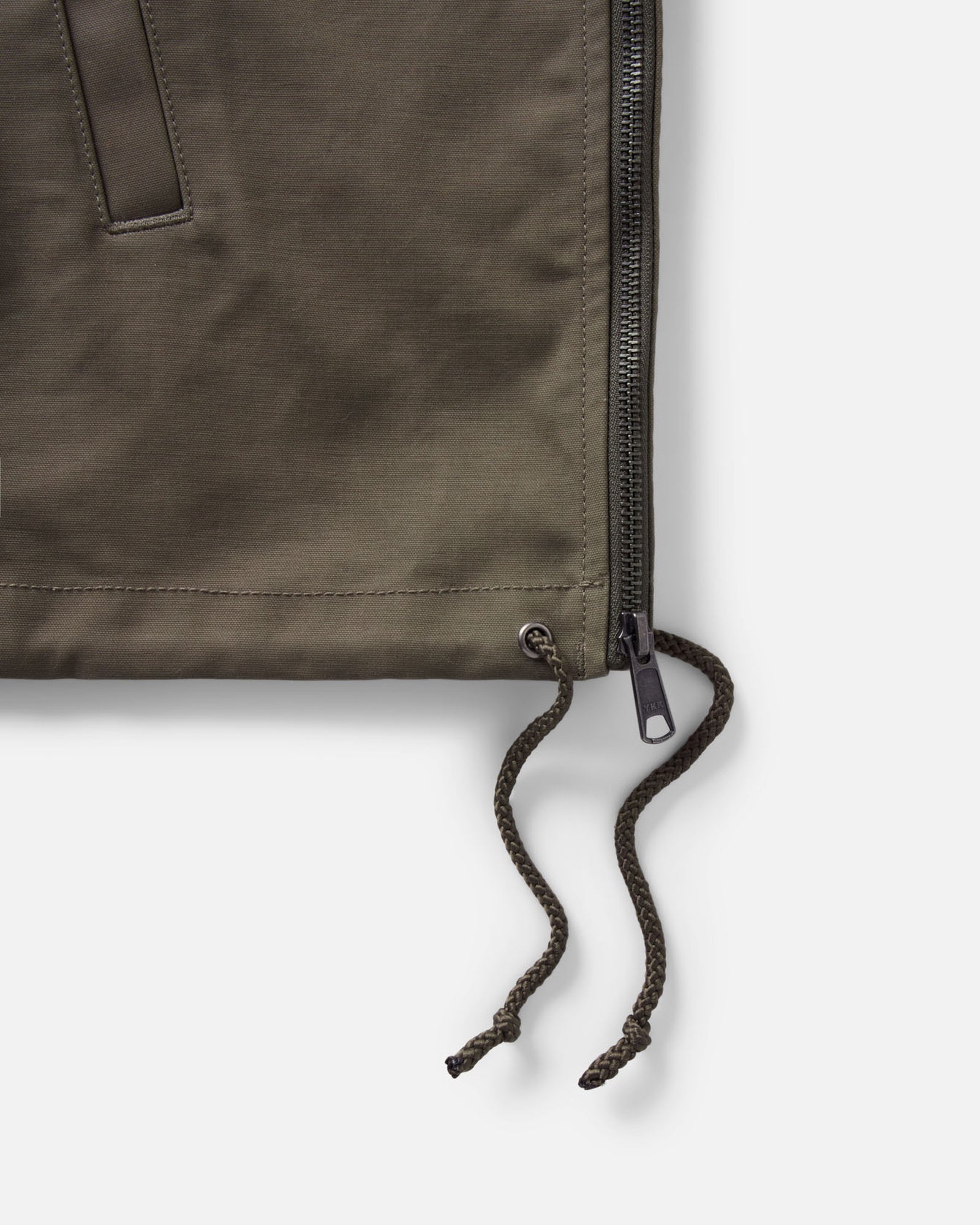 material shot of the zipper on The Hatteras Anorak in Fatigue Olive Dry Wax Canvas, Outerwear by Taylor Stitch