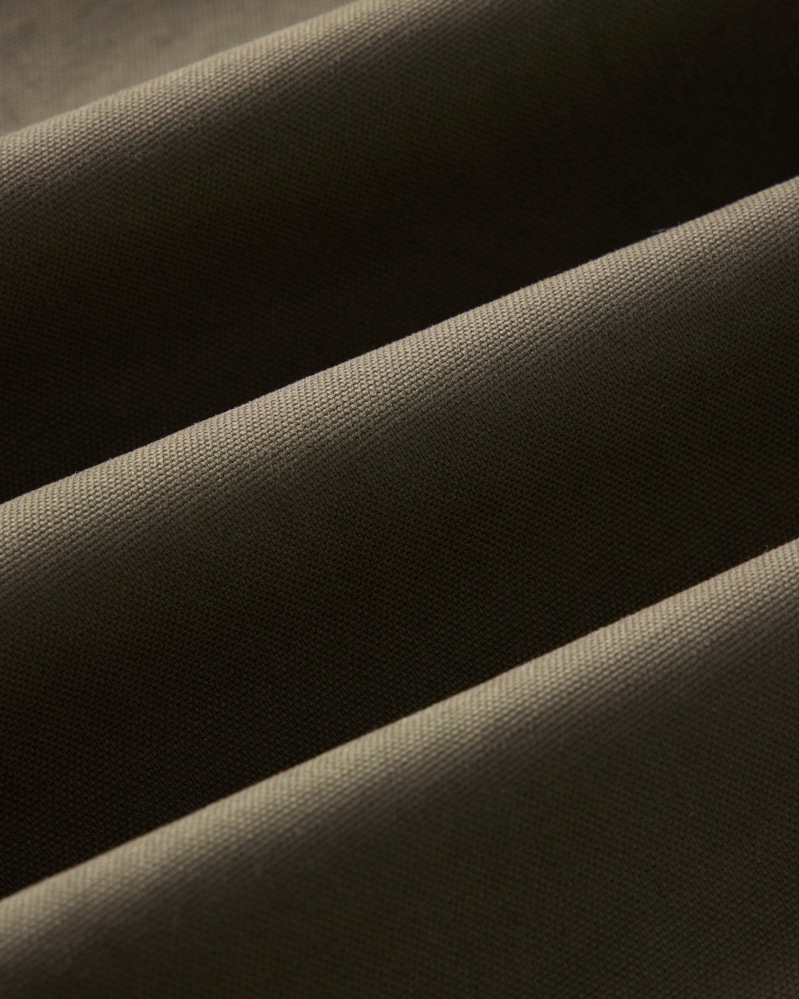 material shot of the fabric on The Hatteras Anorak in Fatigue Olive Dry Wax Canvas, Outerwear by Taylor Stitch