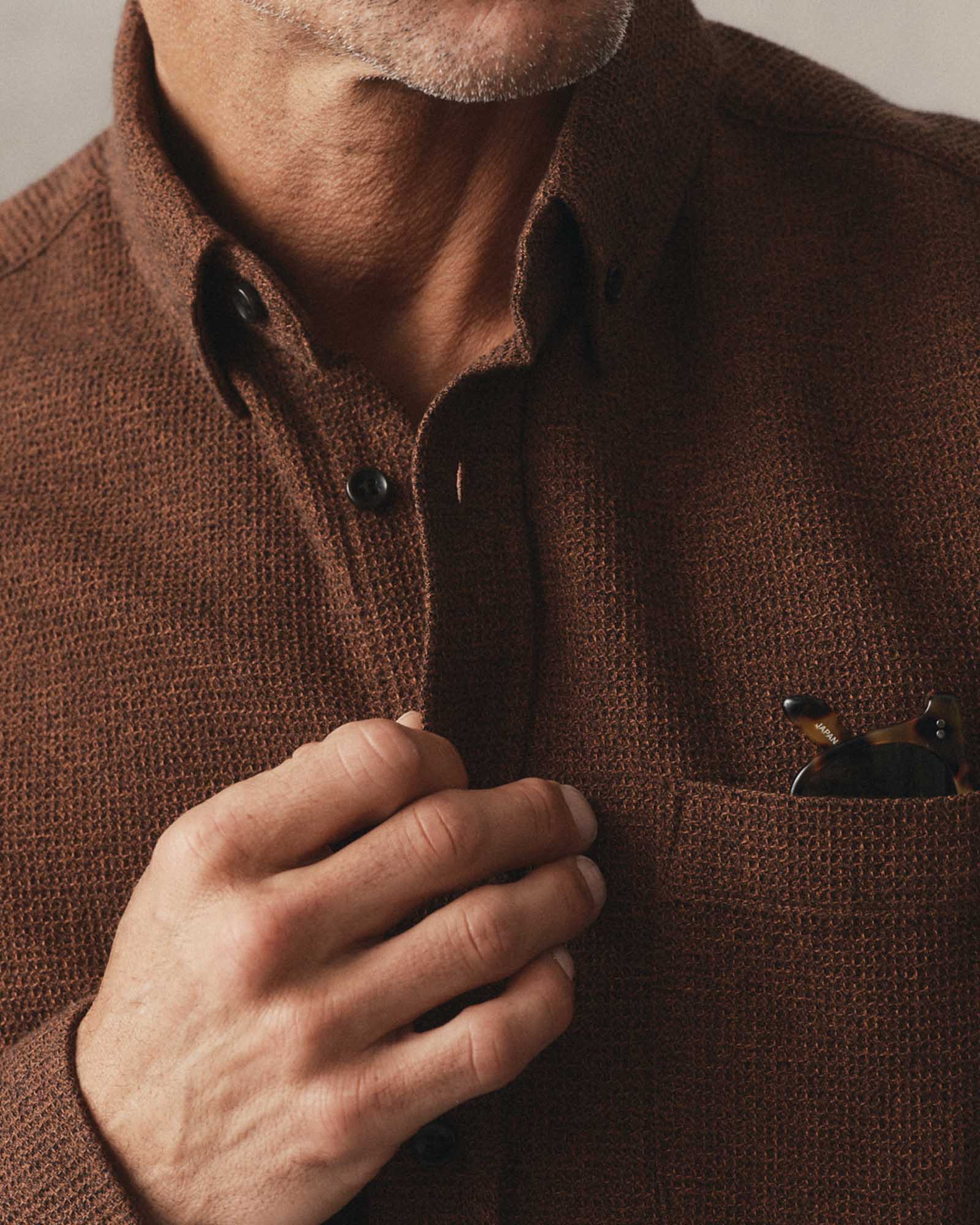 fit model buttoning up The Jack in Timber Twist Waffle, Wovens by Taylor Stitch