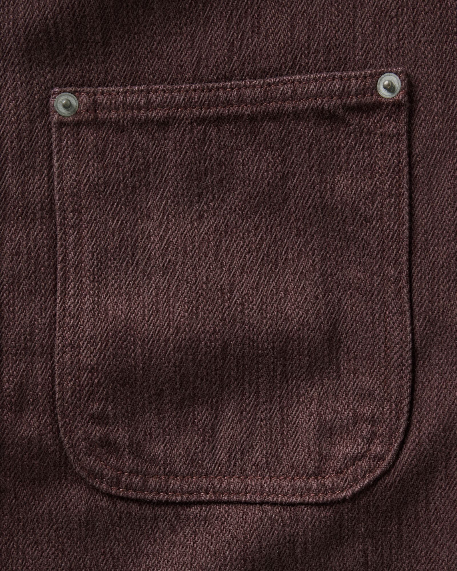 material shot of the pocket on The Milton Overshirt in Burgundy Slub Denim, Outerwear by Taylor Stitch