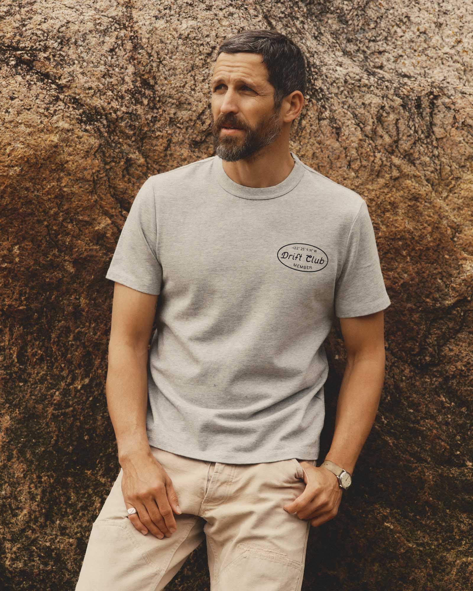 fit model leaning against the wall wearing The Organic Cotton Shop Tee in Drift Club, Knits by Taylor Stitch