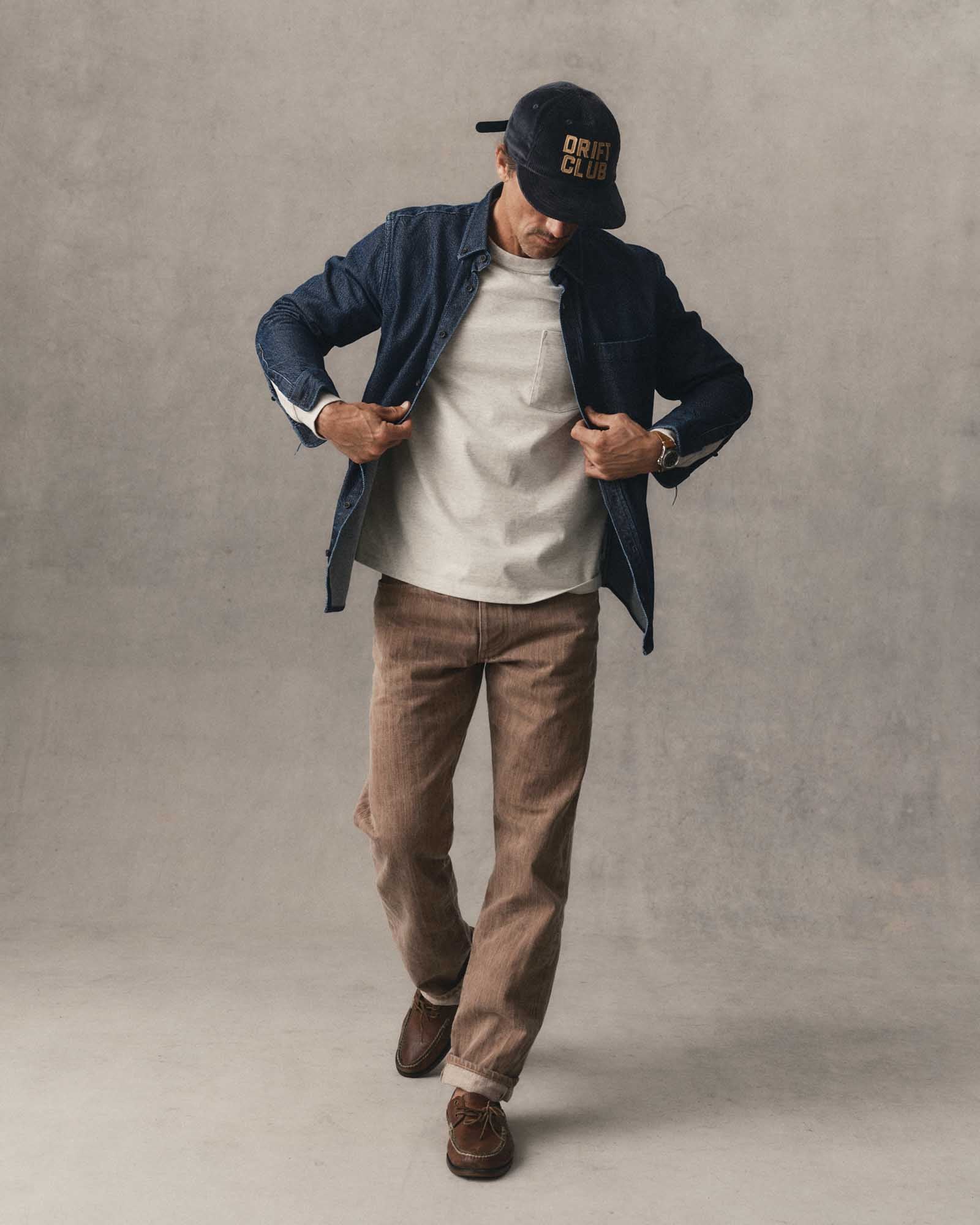 fit model walking wearing The Straight Jean in Kakishibu Selvedge, Bottoms by Taylor Stitch