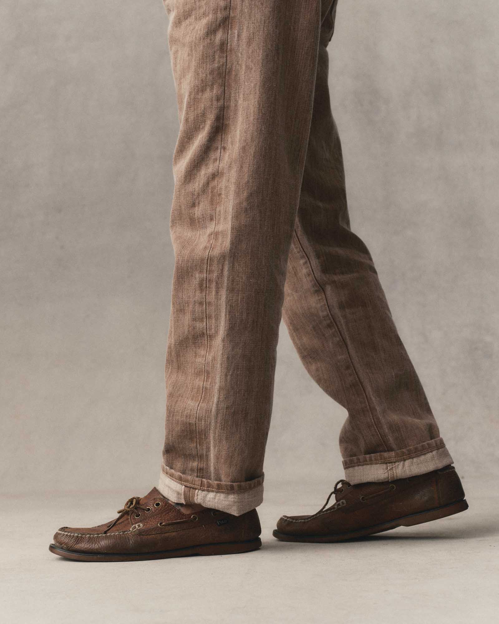 fit model walking wearing The Straight Jean in Kakishibu Selvedge, Bottoms by Taylor Stitch