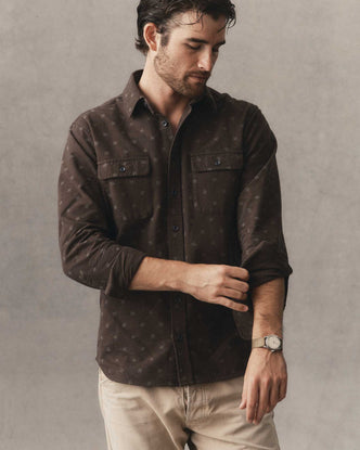 fit model adjusting the sleeve on The Yosemite Shirt in Carolina Geo
