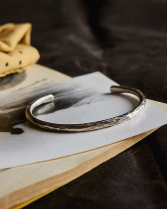 editorial image of The Hammered Cuff in Sterling Silver on a piece of paper