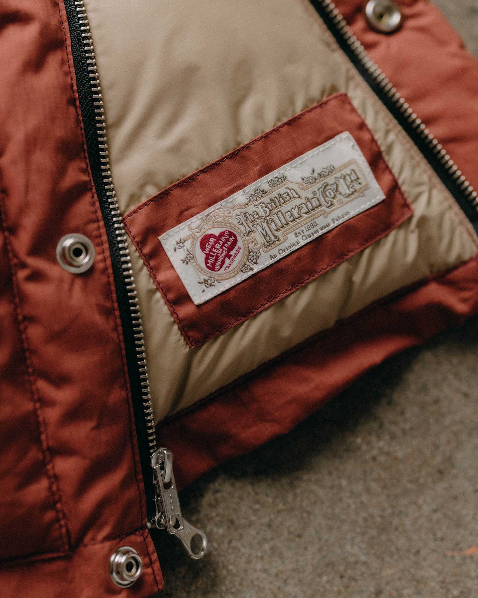 material shot of the inner tag on The Down Vest in Brick Red Waxed Ripstop, Outerwear by Taylor Stitch