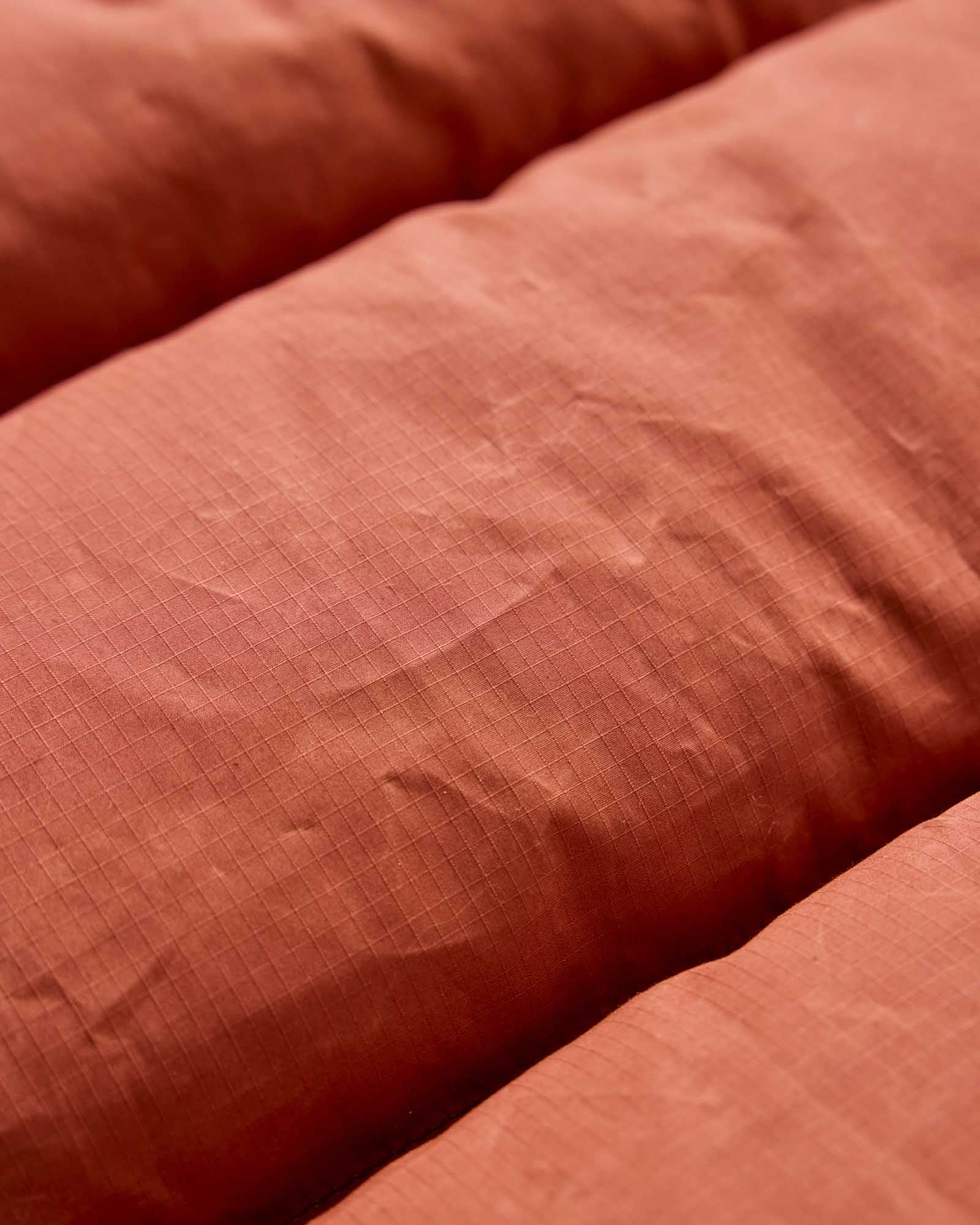 material shot of the fabric on The Down Vest in Brick Red Waxed Ripstop, Outerwear by Taylor Stitch