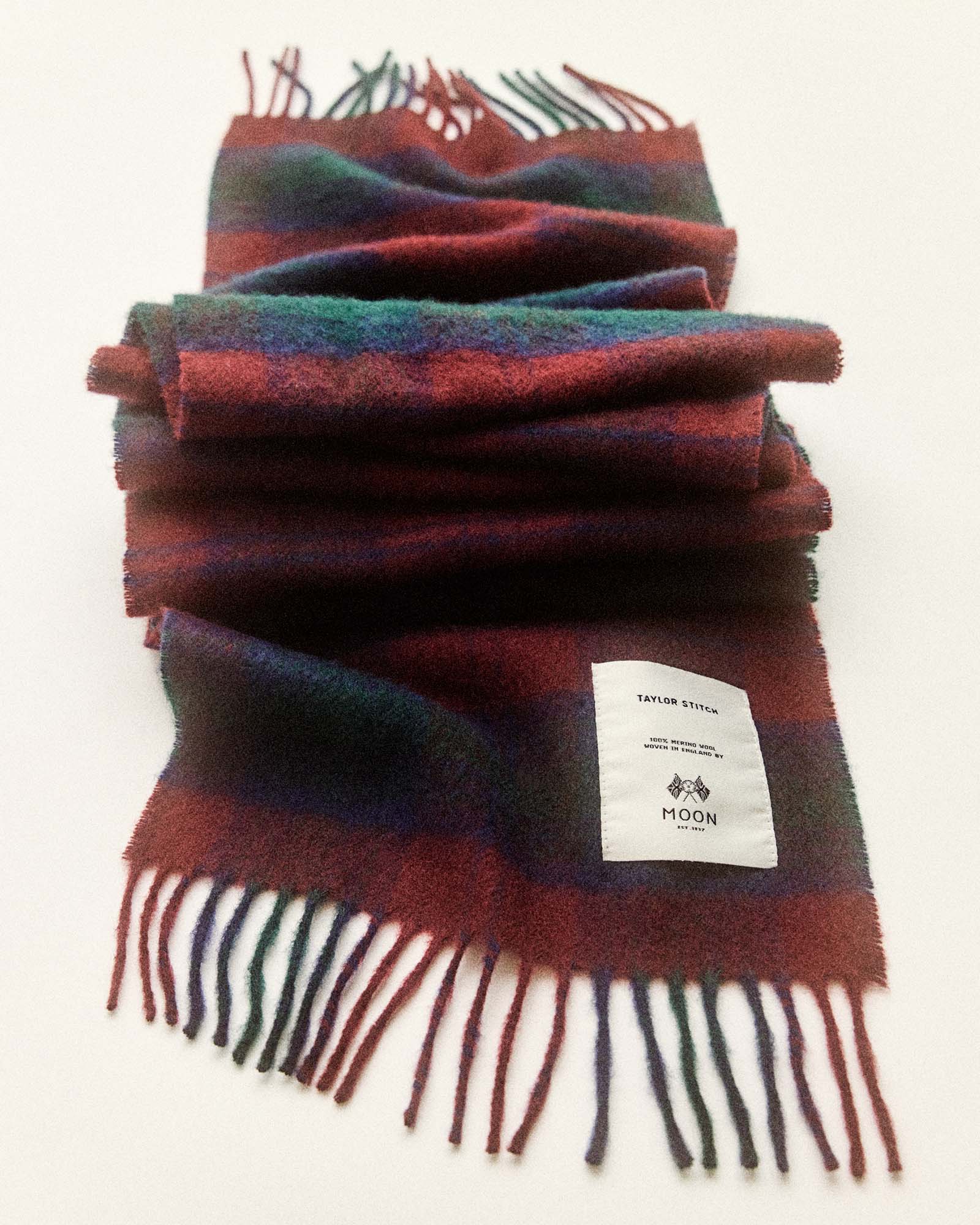 editorial flatlay of The Fireside Scarf in Currant Plaid, Accessories by Taylor Stitch