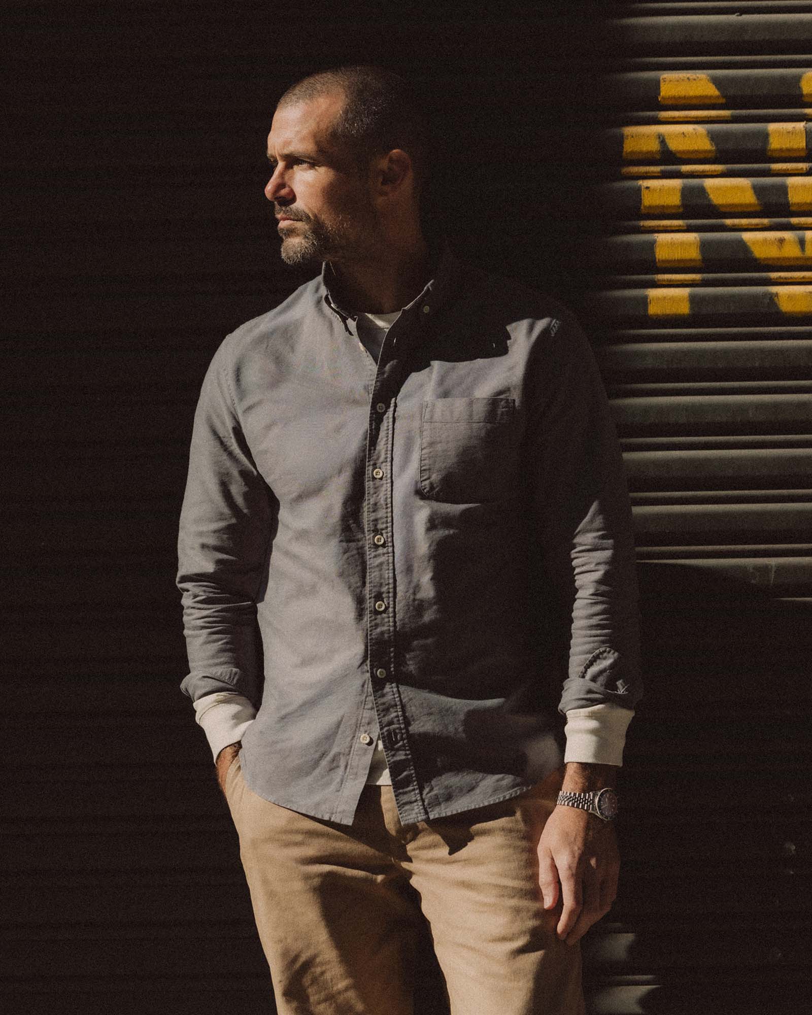 fit model sitting in The Jack in Smoke Oxford, Wovens by Taylor Stitch