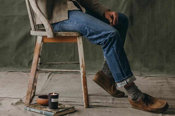 Model sitting in The Democratic Jean in Mid Wash Organic Selvedge