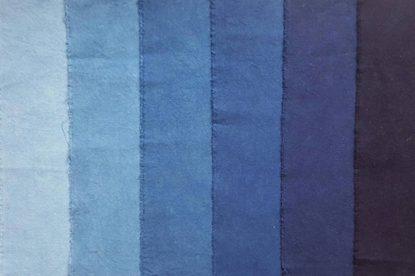a shot of fabric dyed in different tones of indigo