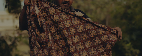 editorial image of designer holding fabric for India Craft
