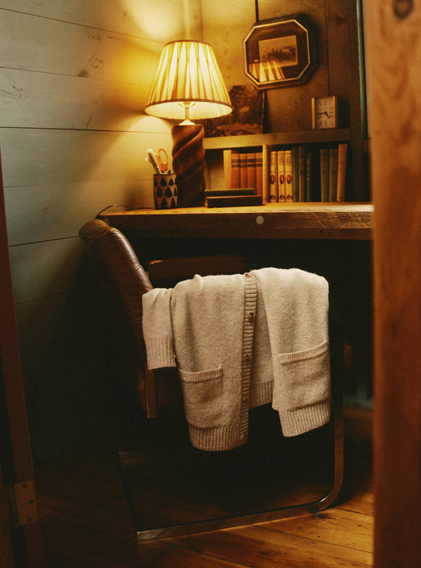 editorial image of The Eastmoor Cardigan in Oatmeal Wool on a chair