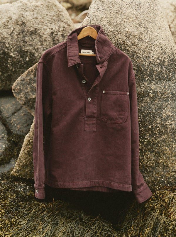 editorial image of The Milton Overshirt in Burgundy Slub Denim hanging