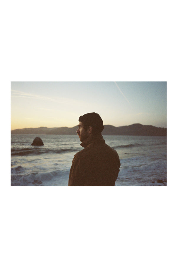 A film photo of a man at the ocean