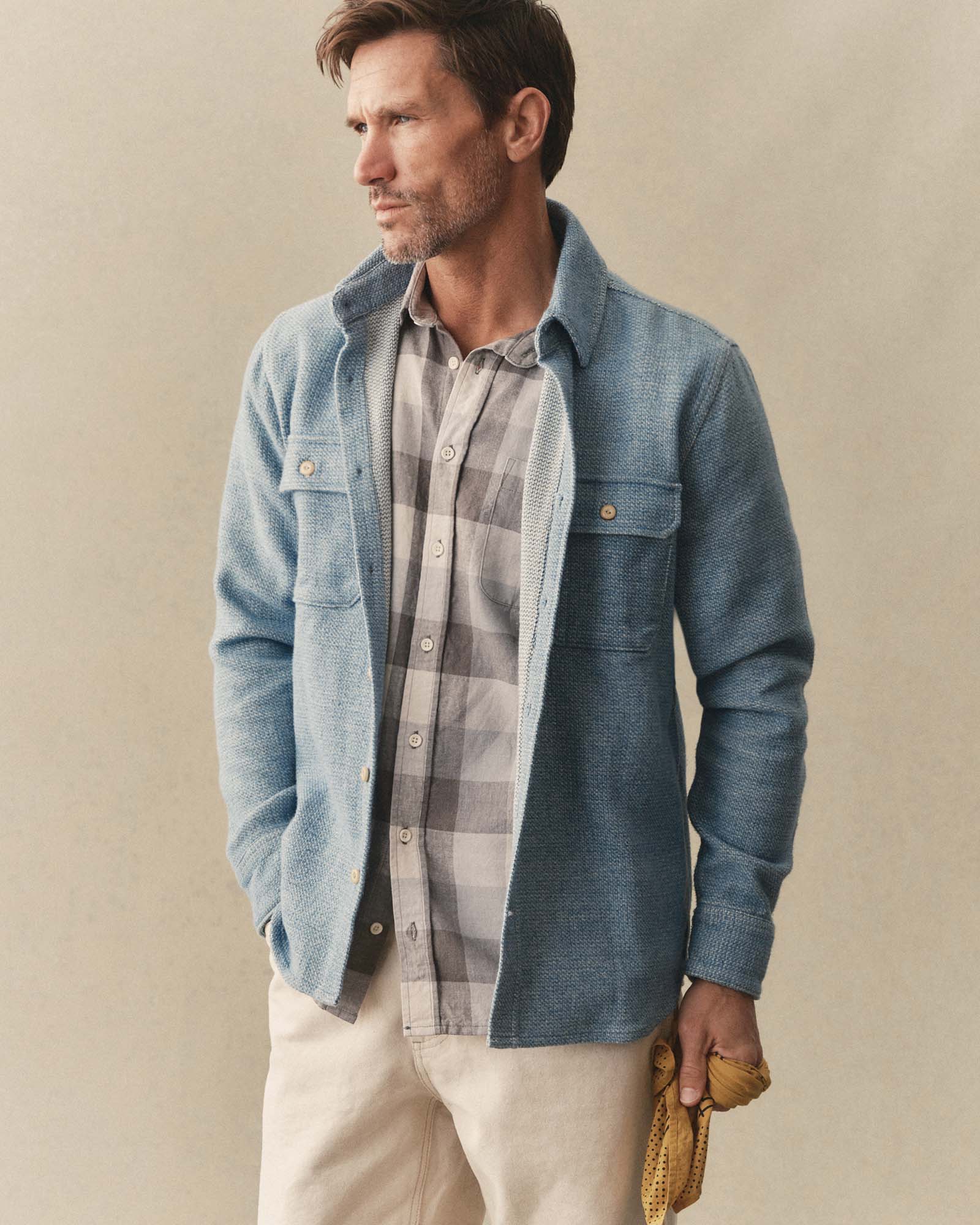 fit model sitting wearing The Division Shirt in Washed Indigo, Wovens by Taylor Stitch