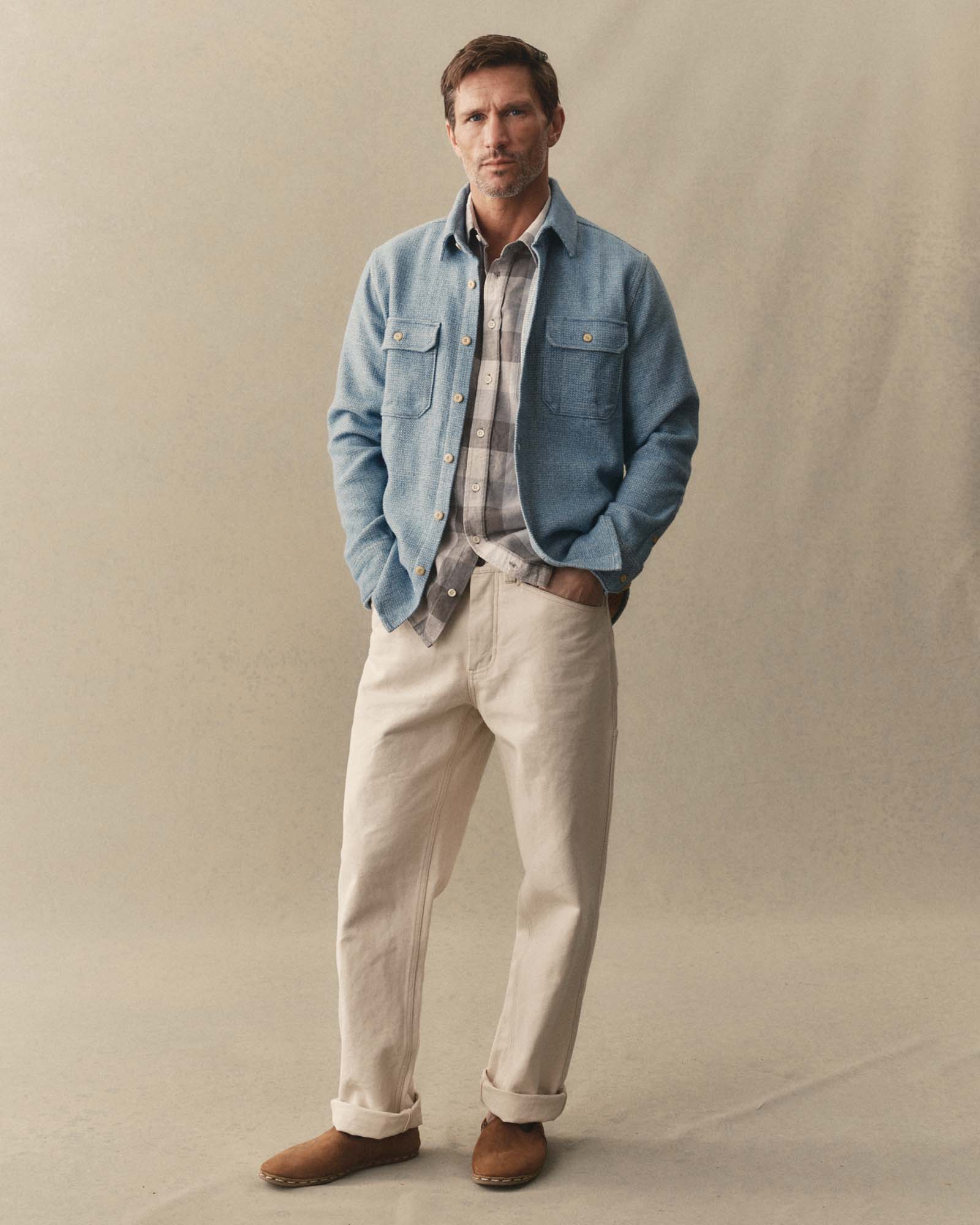 fit model adjusting sleeve on The Division Shirt in Washed Indigo, Wovens by Taylor Stitch
