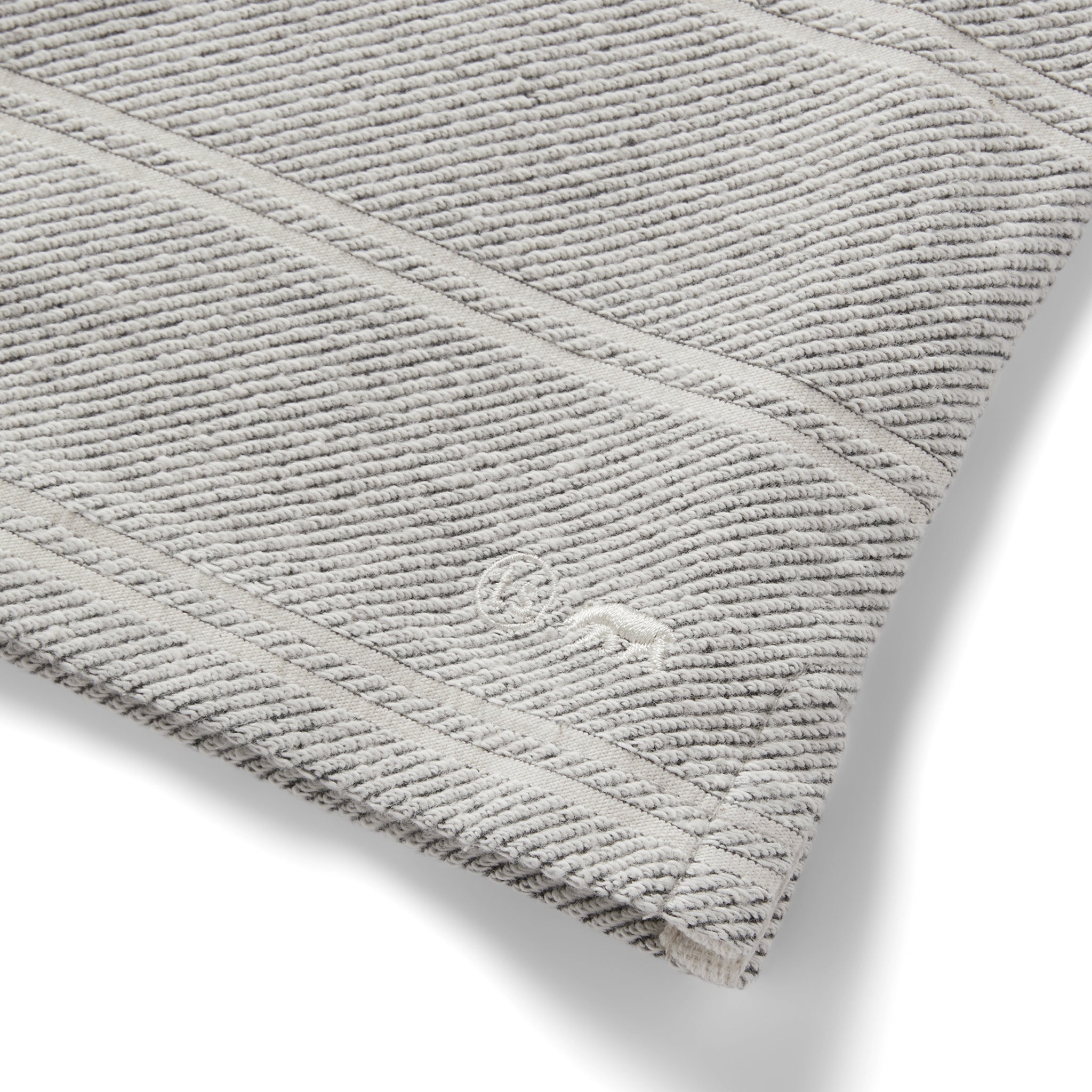 material shot of the logo on The Morgan Crewneck in Ash Stripe, Knits by Taylor Stitch