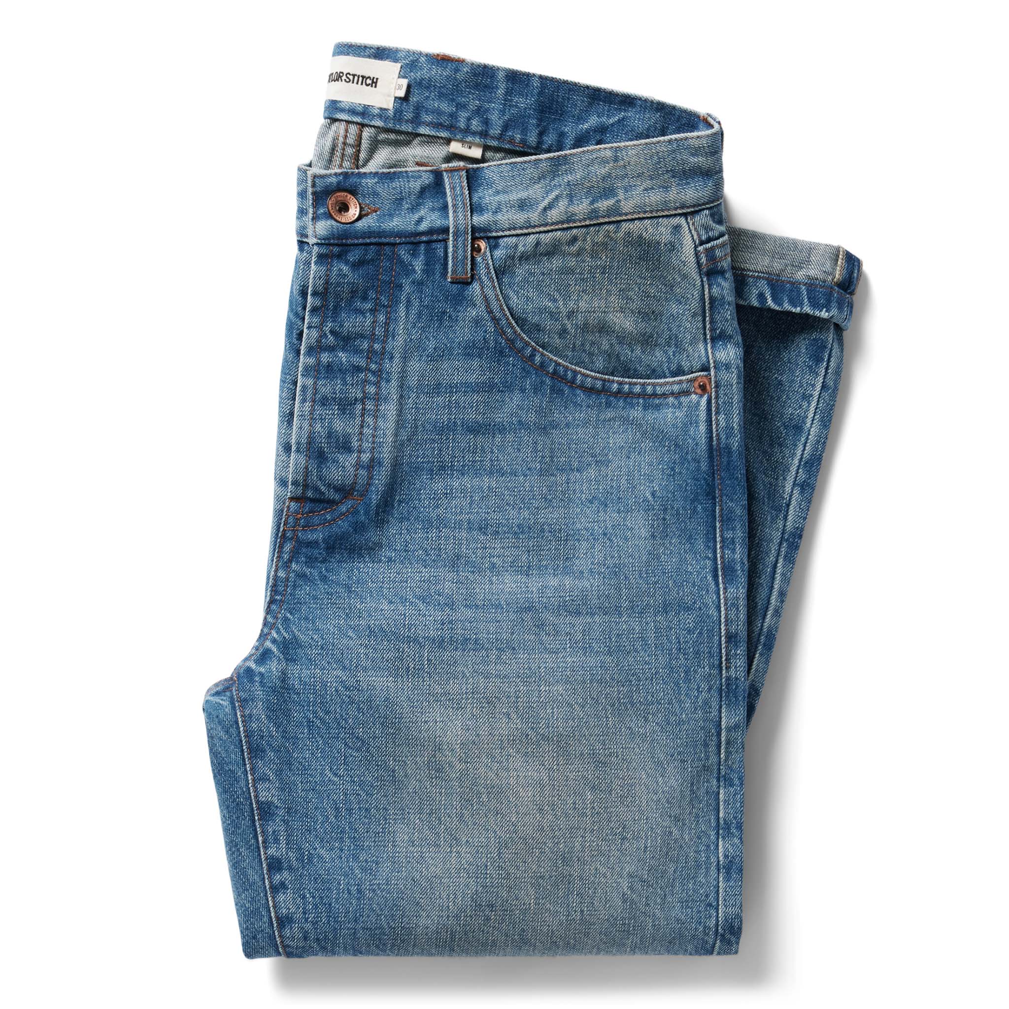 flatlay of The Slim Jean in Fletcher Wash Organic Selvage folded, Bottoms by Taylor Stitch