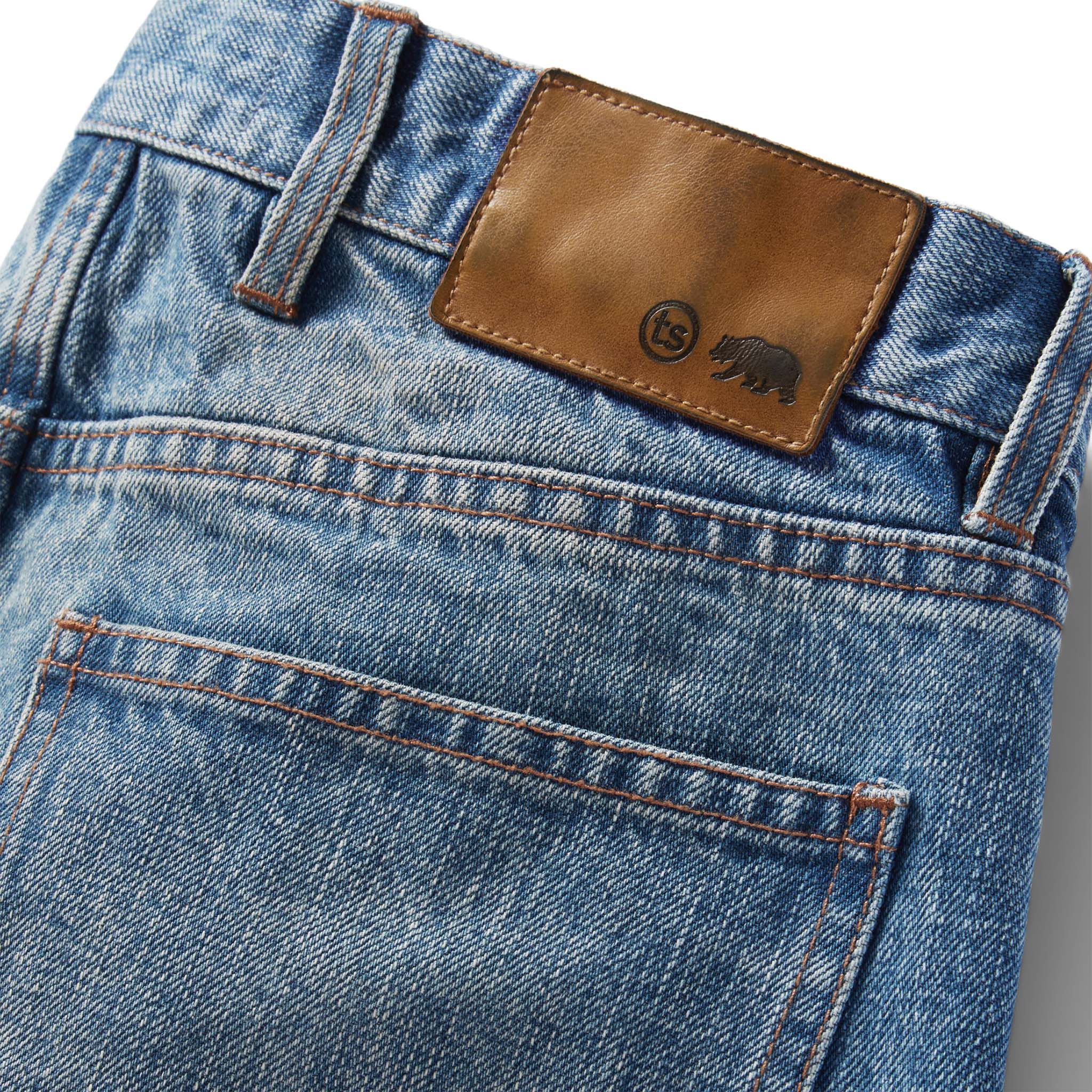 material shot of the logo patch on The Slim Jean in Fletcher Wash Organic Selvage, Bottoms by Taylor Stitch