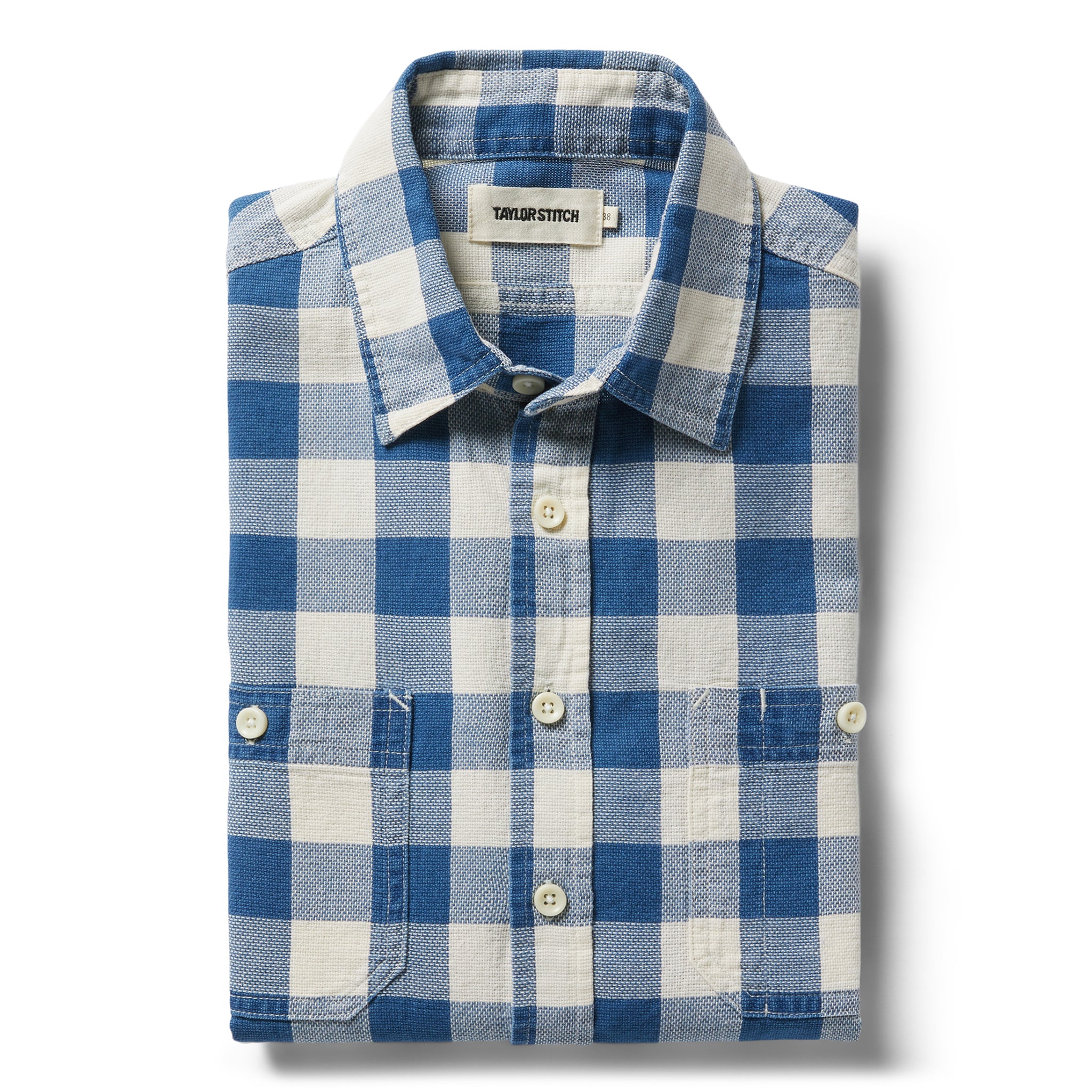 flatlay of The Utility Shirt in Sun Bleached Indigo Check folded, Wovens by Taylor Stitch