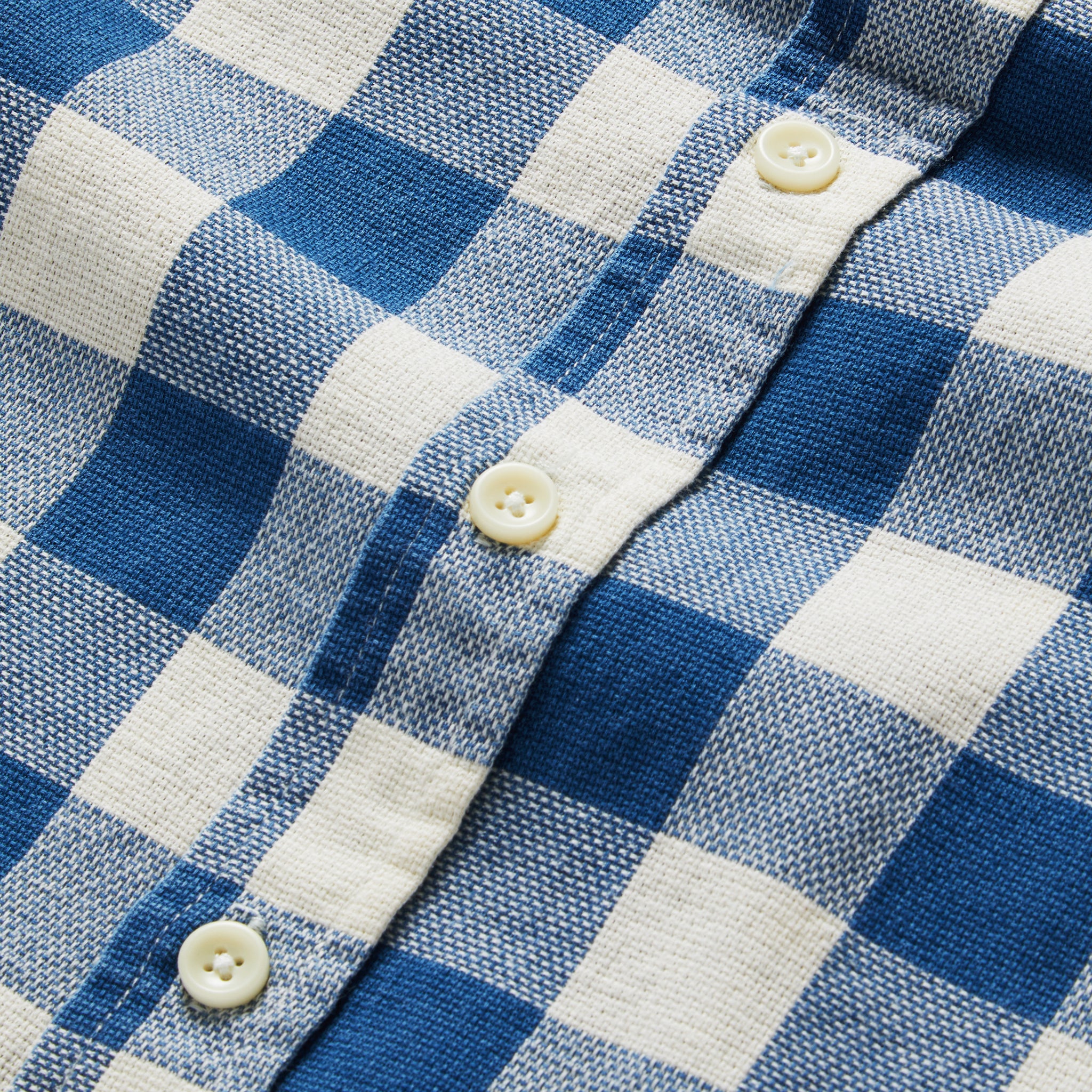 material shot of the buttons on The Utility Shirt in Sun Bleached Indigo Check, Wovens by Taylor Stitch