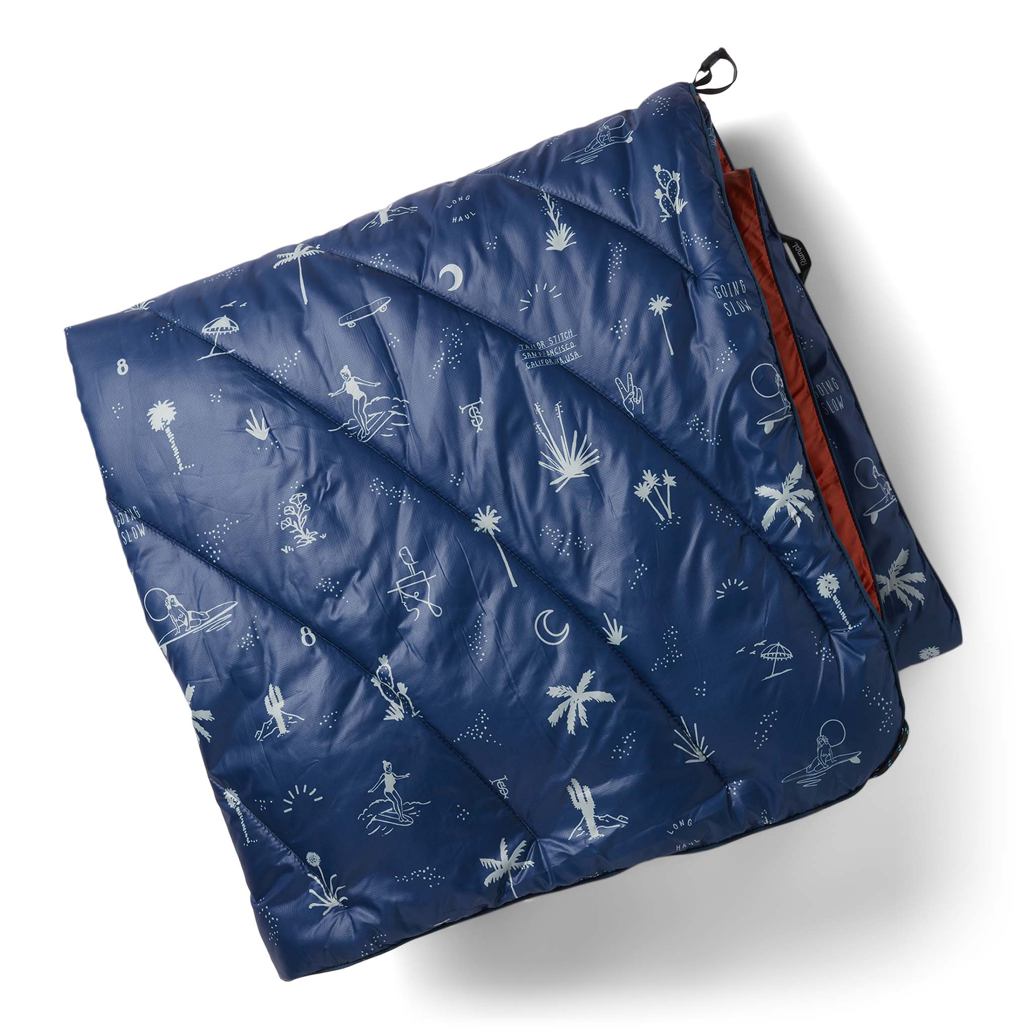 flatlay of The Original Puffy Blanket in Navy Aloha, Accessories by Taylor Stitch