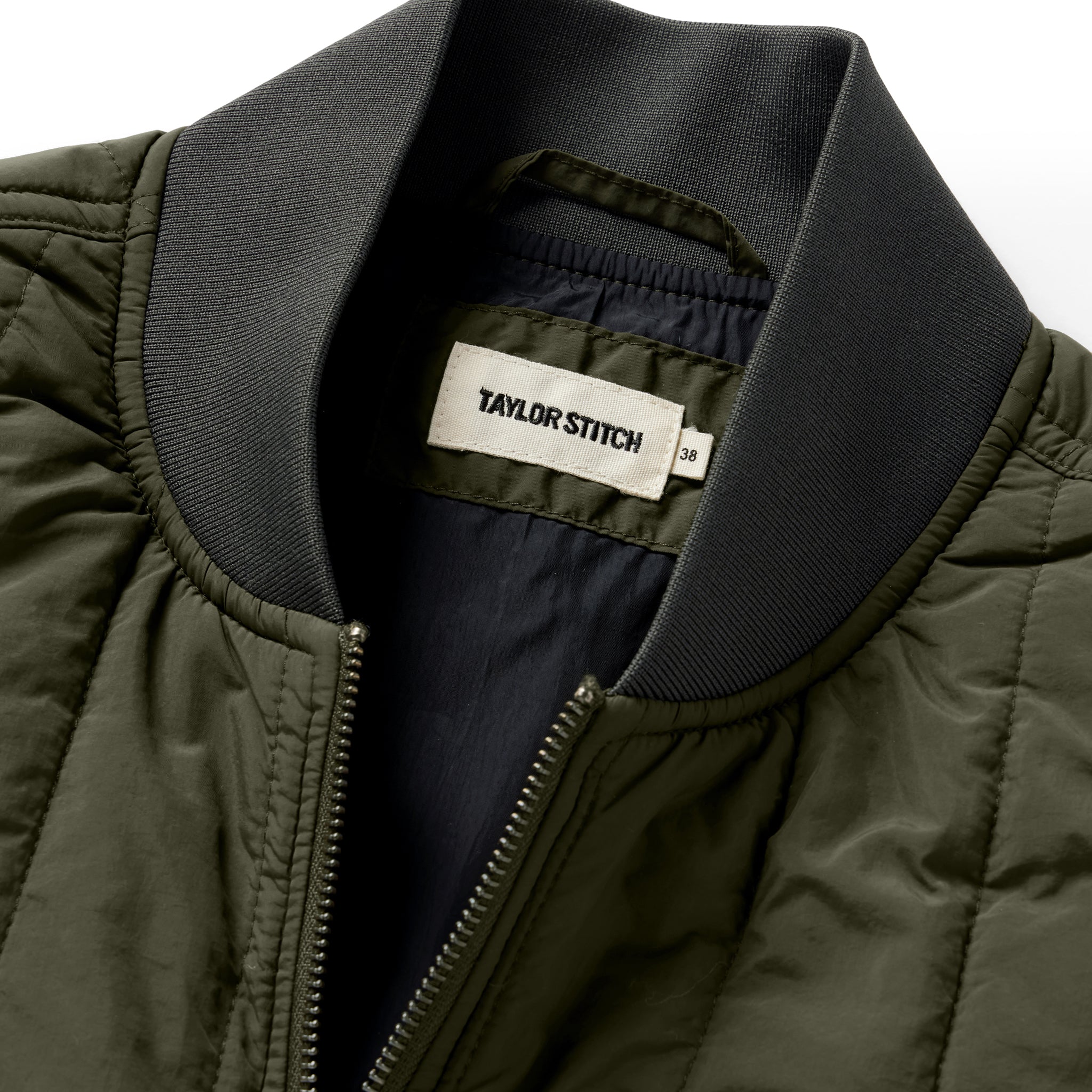 material shot of the neck opening on The Able Vest in Quilted Army, Outerwear by Taylor Stitch