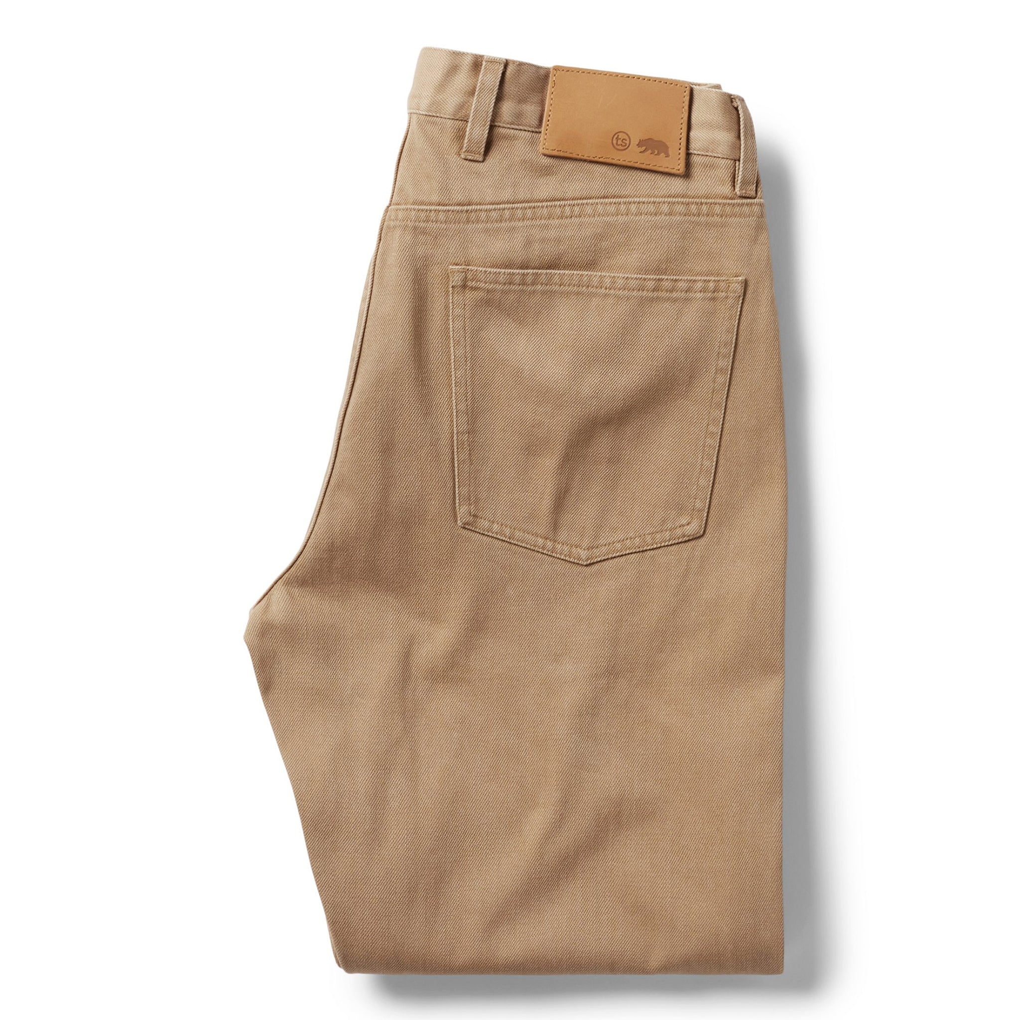 flatlay of The Democratic All Day Pant in Washed Tobacco Selvage, shown folded from back, Bottoms by Taylor Stitch