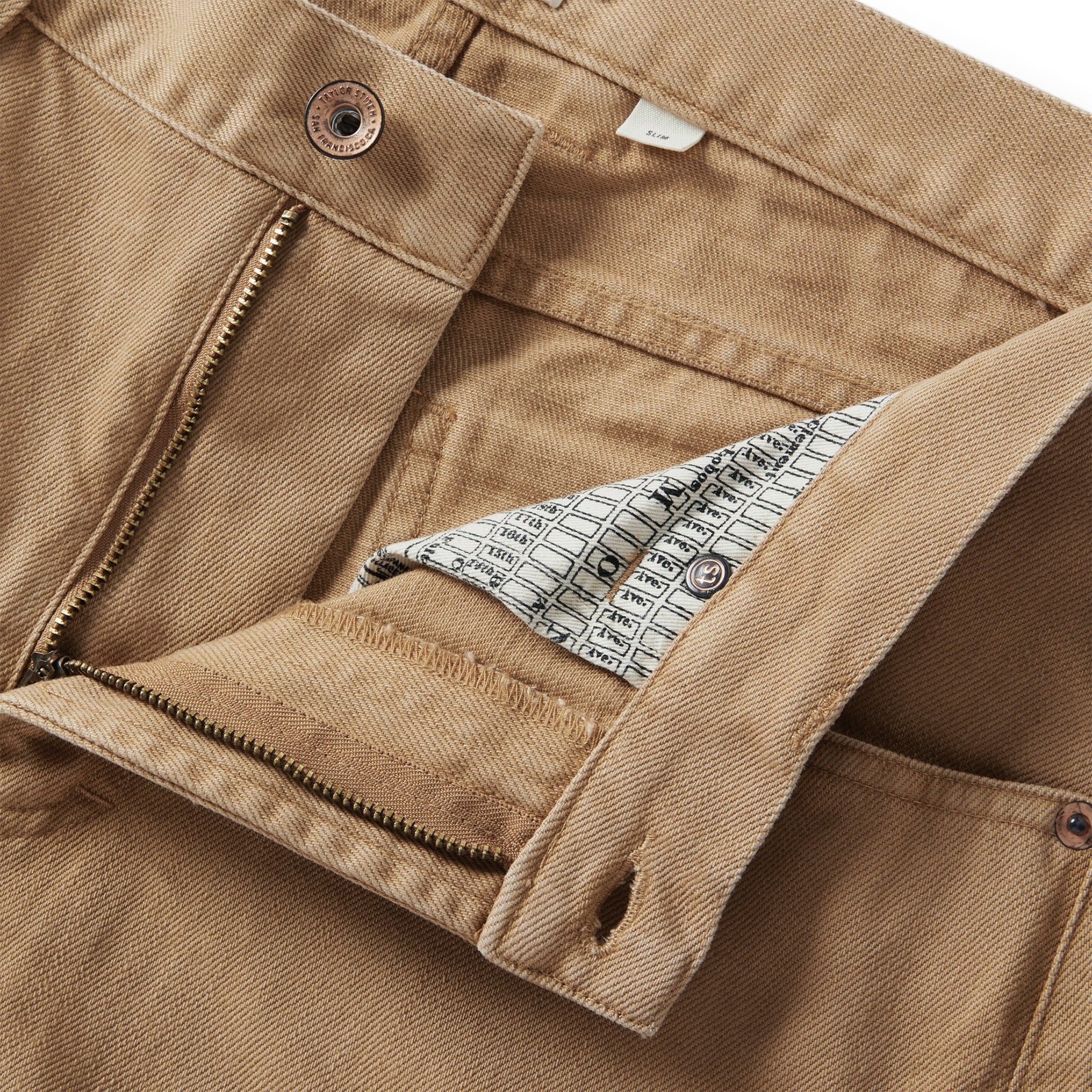 material shot of the YKK zipper on The Democratic All Day Pant in Washed Tobacco Selvage, Bottoms by Taylor Stitch