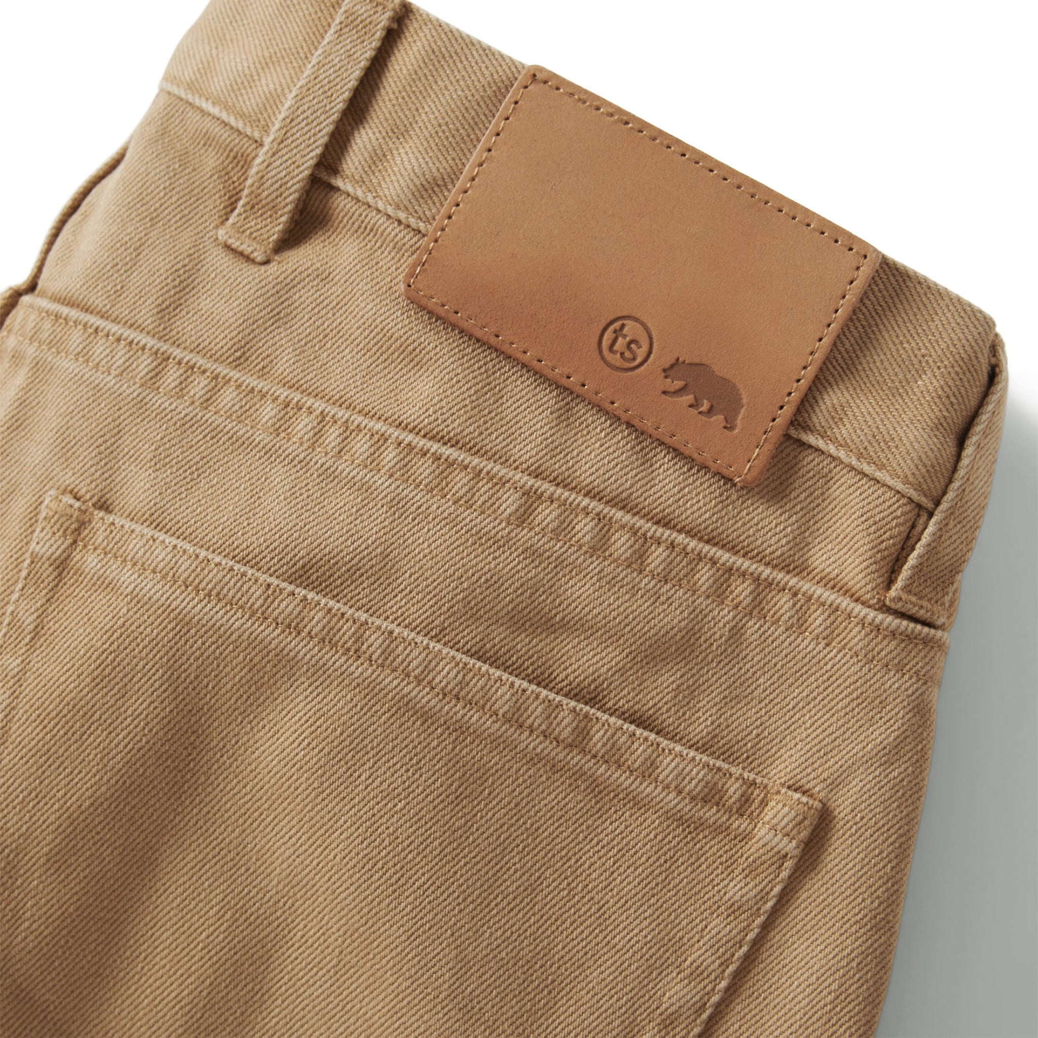 material shot of the leather patch on The Democratic All Day Pant in Washed Tobacco Selvage, Bottoms by Taylor Stitch