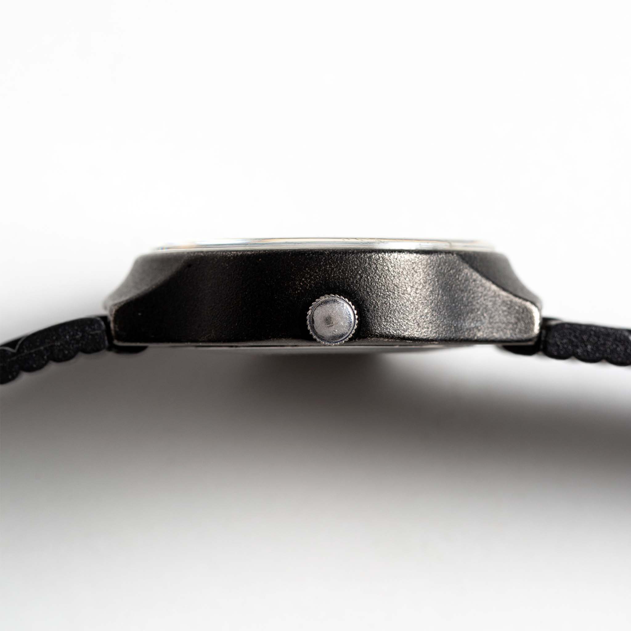 flatlay of the 1978 Timex Black Max, shown from the side, Accessories by Taylor Stitch