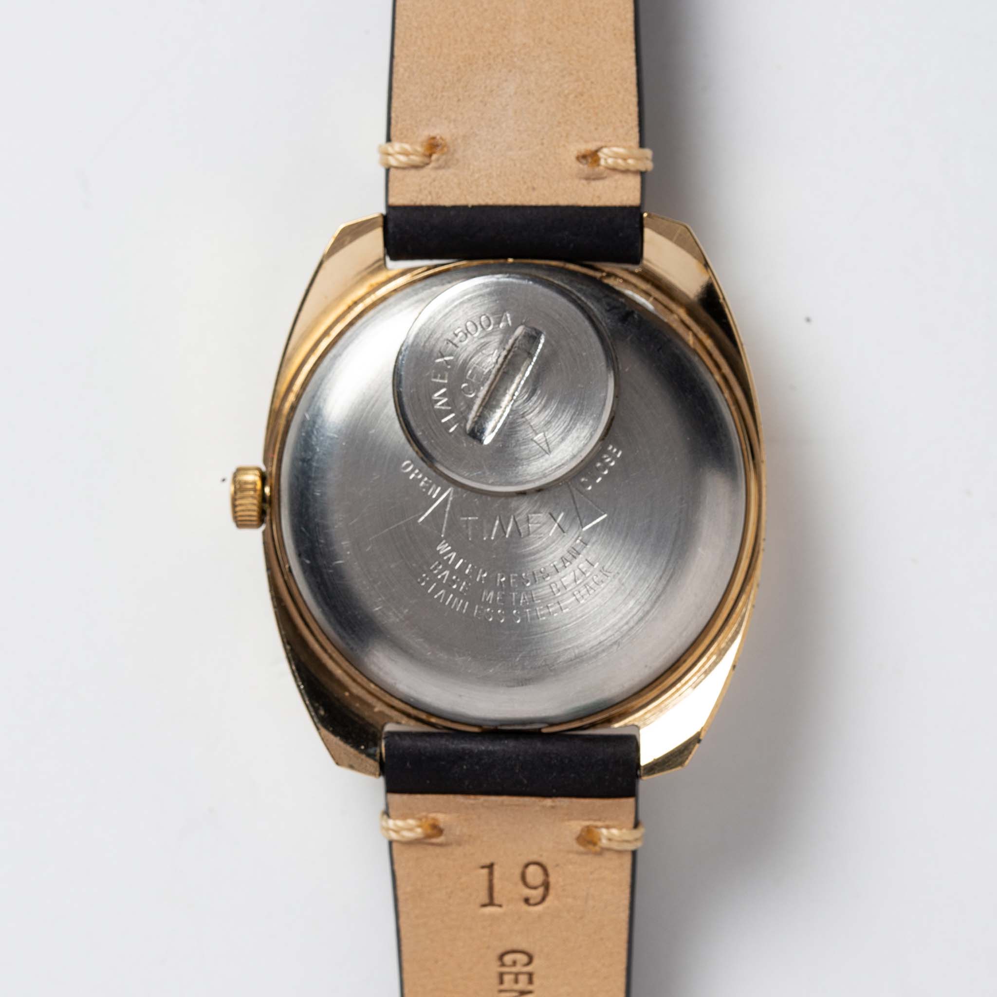 flatlay of the 1978 Timex Q Quartz, shown from the back, Accessories by Taylor Stitch