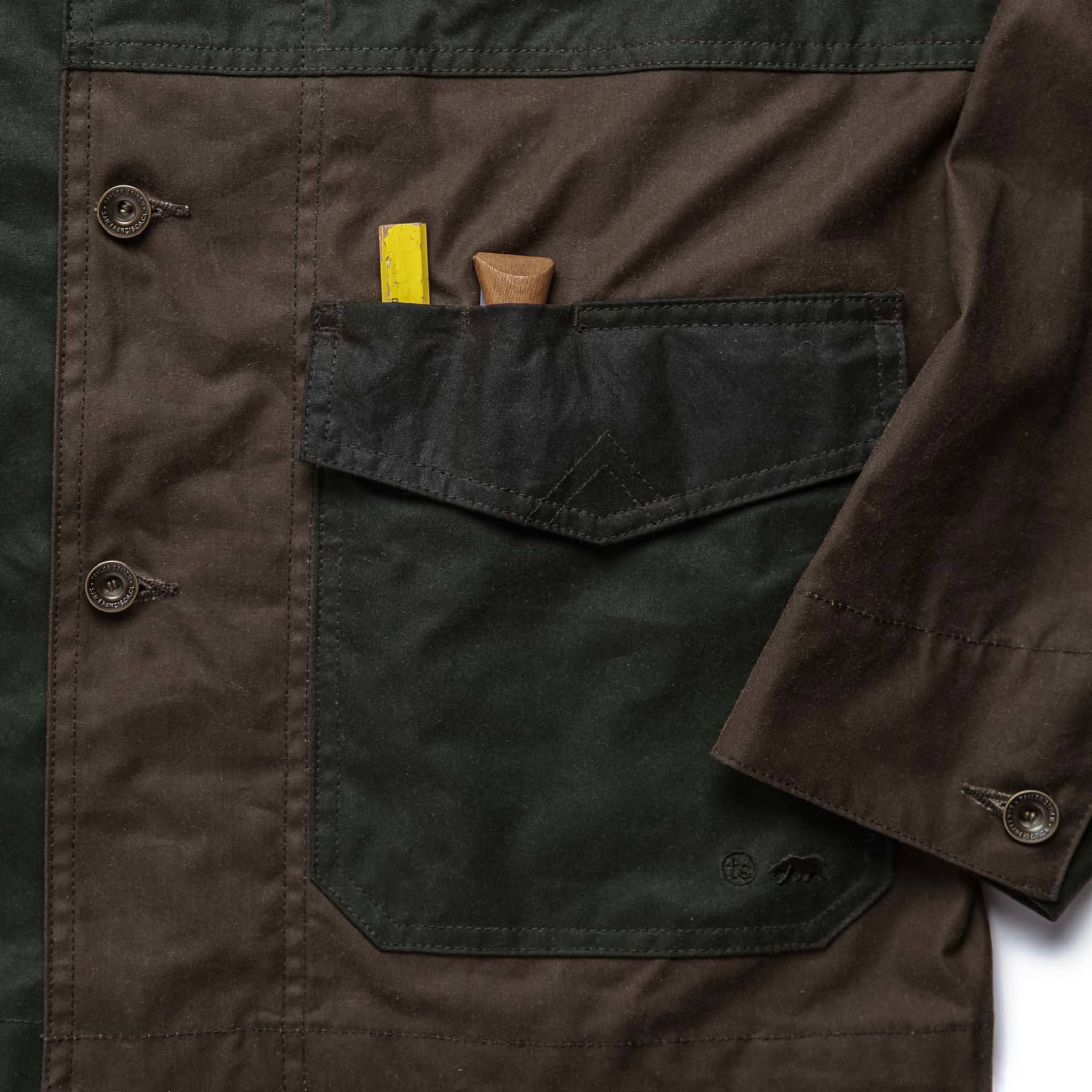 material shot of front pocket of The Task Jacket in Waxed Khaki and Olive Patchwork, Outerwear by Taylor Stitch
